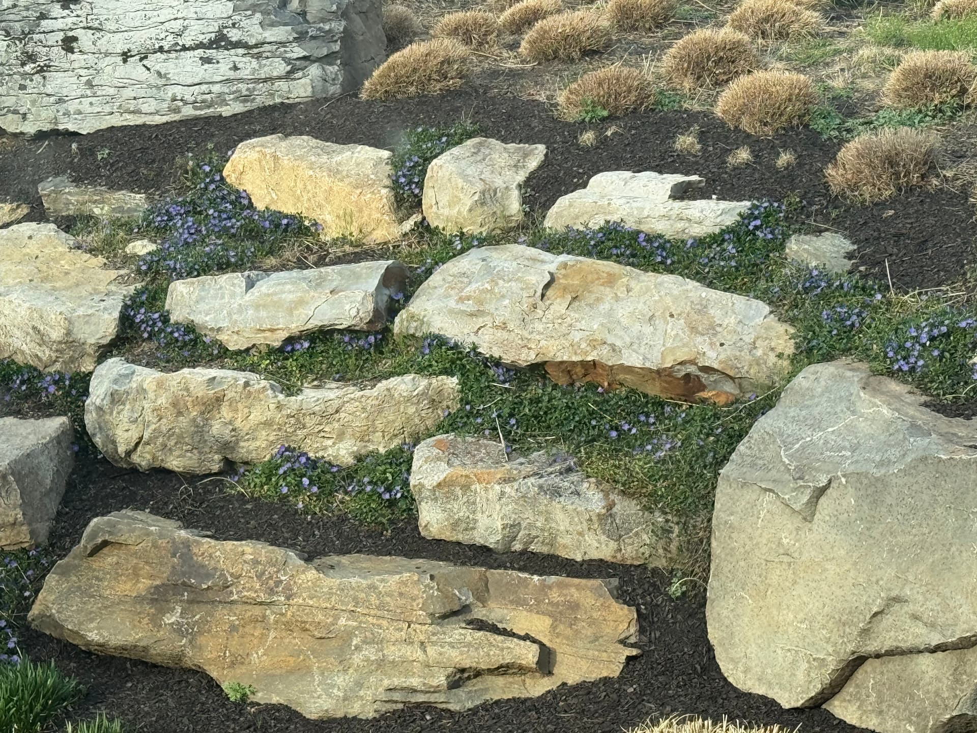 Boulder Walls, Bluestone Walkways and Layered Plantings Done Right