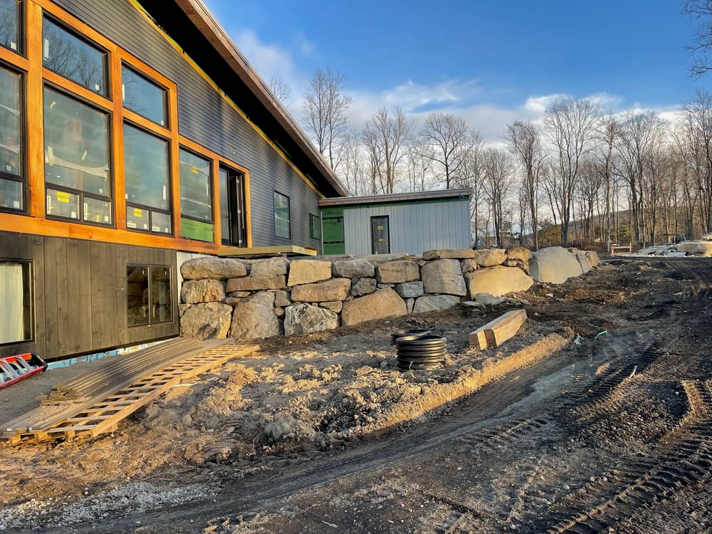 Boulder Retaining Wall Built Alongside New Construction in Wappingers Falls image